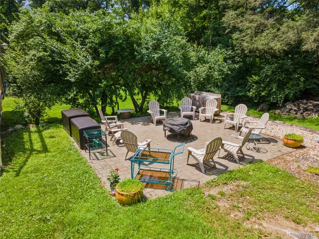 a view of a backyard with sitting area