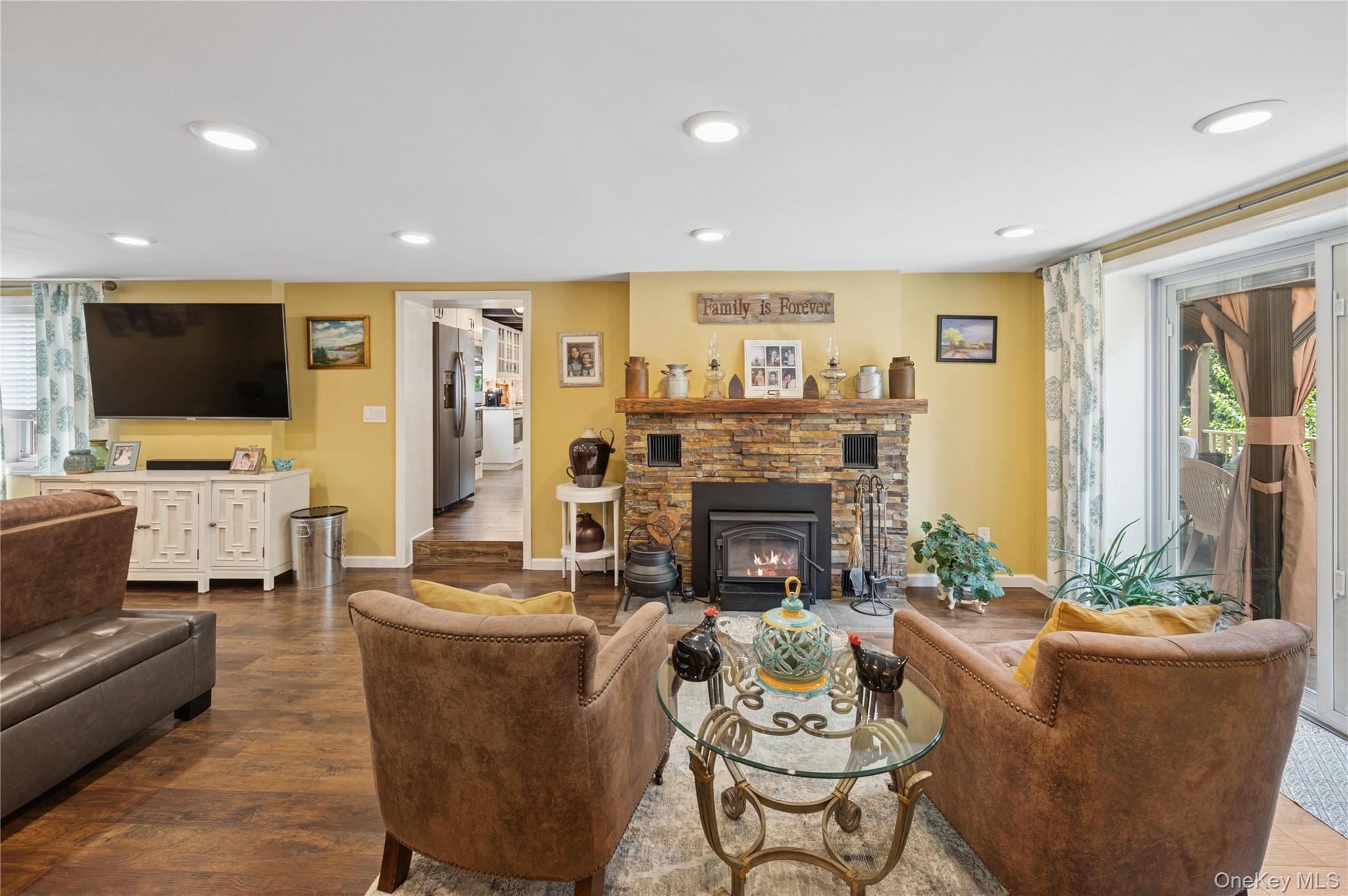 123 Pleasant Road Lake Peekskill, NY 10537 - Photo 5 of 50 a living room with furniture a fireplace and a flat screen tv