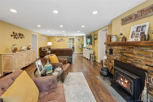 a living room with furniture flat screen tv and a fireplace