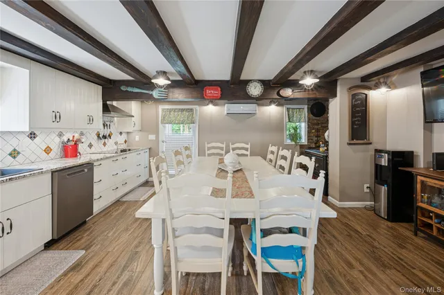 a view of a kitchen with furniture and wooden floor