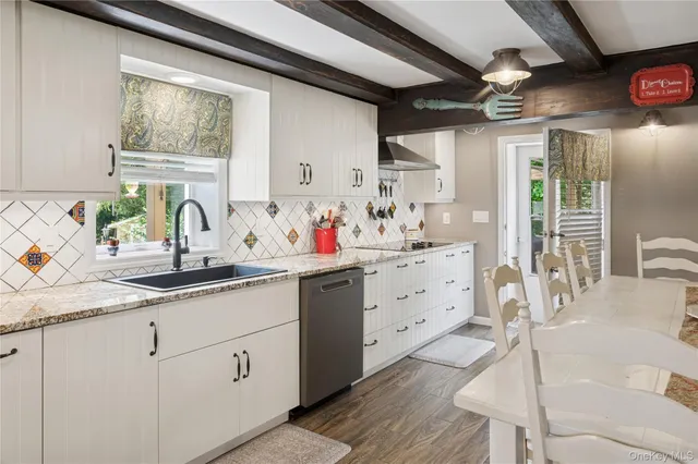 a kitchen with sink cabinets and window