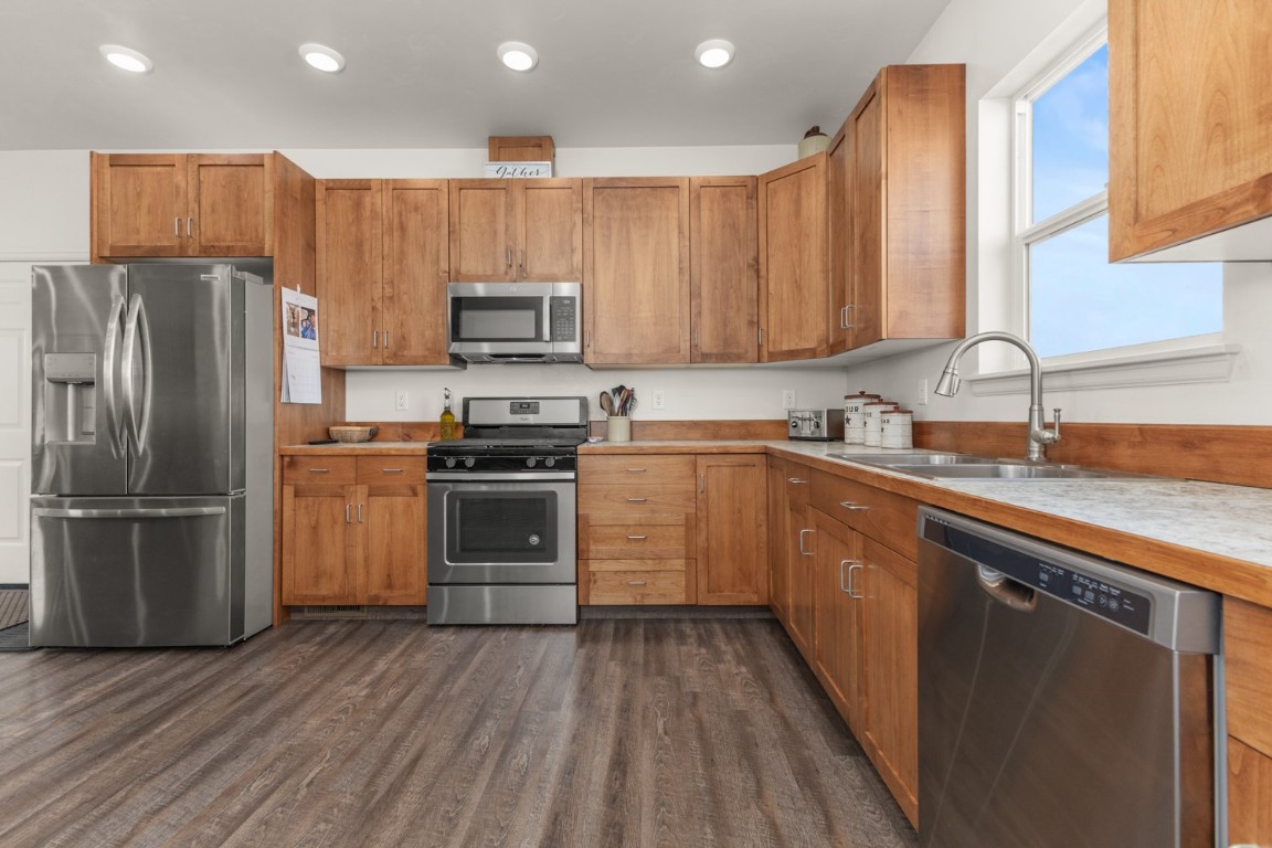984 Dry Creek Road Hayden, CO 81639 - Photo 9 of 30 a kitchen with a sink a microwave a refrigerator and cabinets