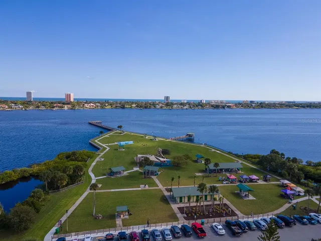a kitchen with stainless steel appliances kitchen island wooden floors granite counter tops and a window