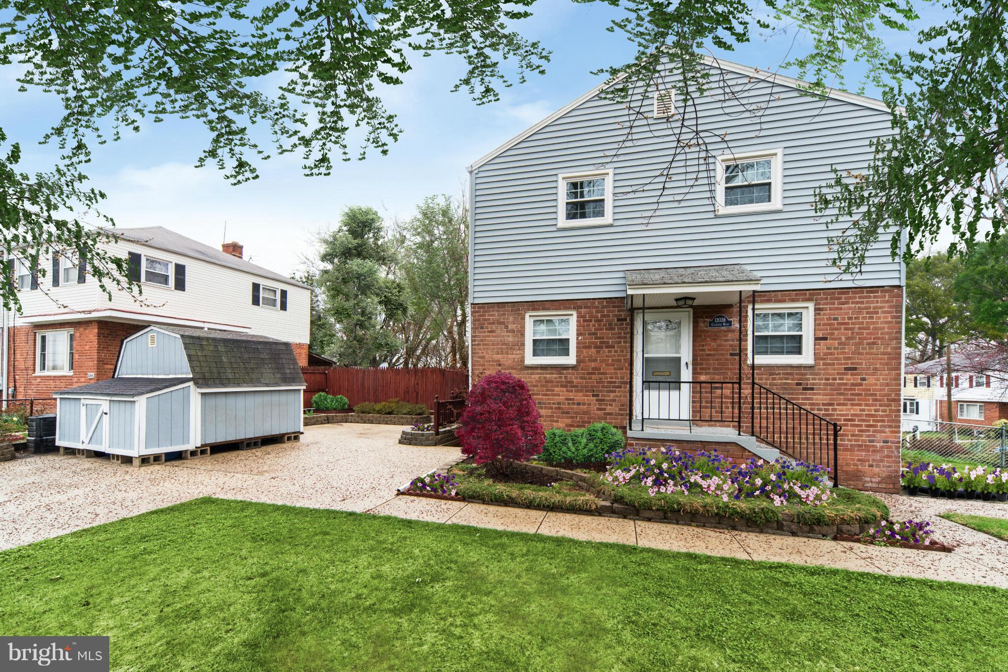12036 Claridge Road Silver Spring, MD 20902 - Photo 2 of 27 a front view of a house with a garden and plants