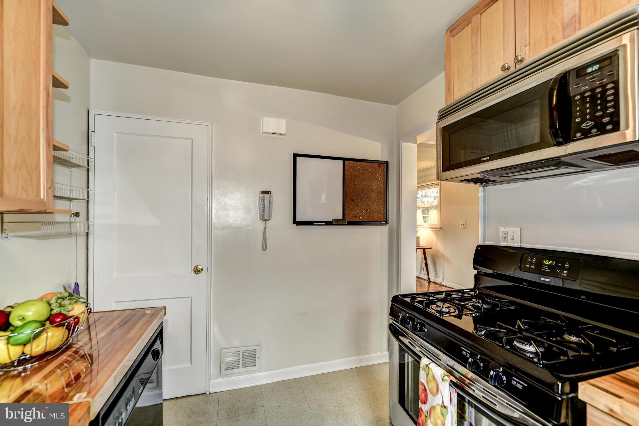 12036 Claridge Road Silver Spring, MD 20902 - Photo 11 of 27 a kitchen with stainless steel appliances granite countertop a stove and a microwave