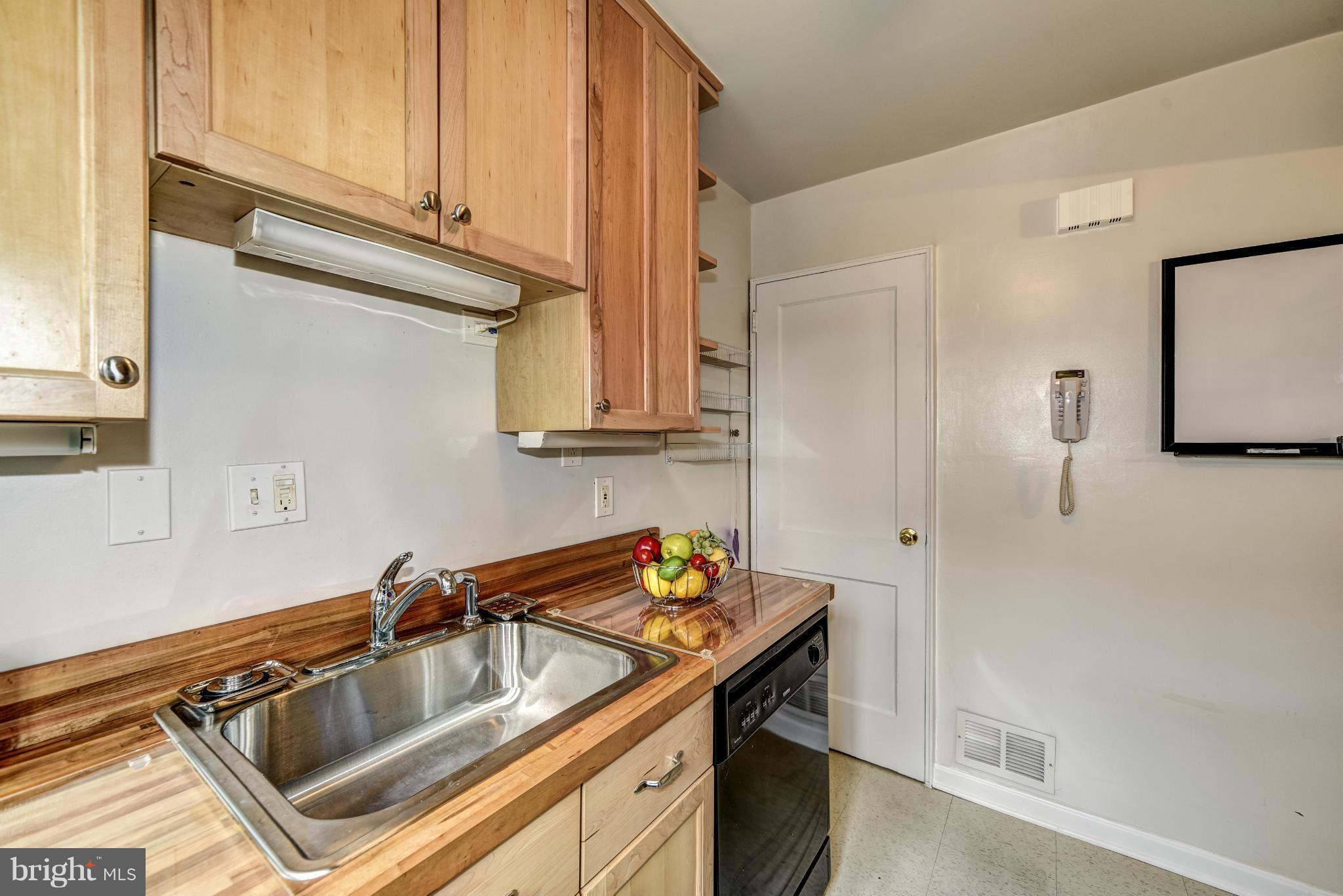 12036 Claridge Road Silver Spring, MD 20902 - Photo 12 of 27 a kitchen that has a sink and a stove