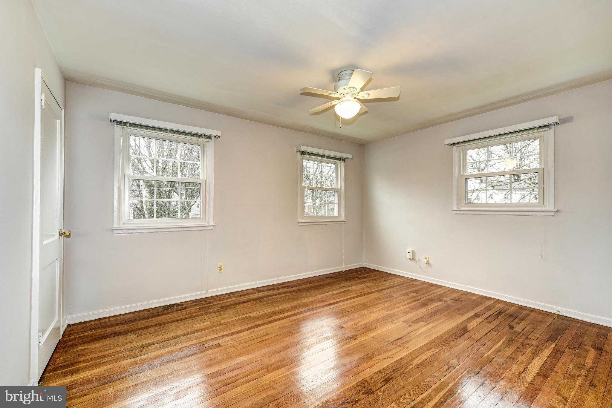 12036 Claridge Road Silver Spring, MD 20902 - Photo 13 of 27 a view of empty room with wooden floor and fan