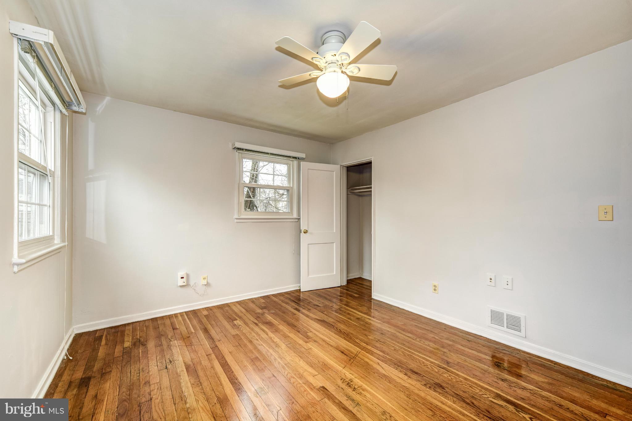 12036 Claridge Road Silver Spring, MD 20902 - Photo 14 of 27 wooden floor in an empty room with a window