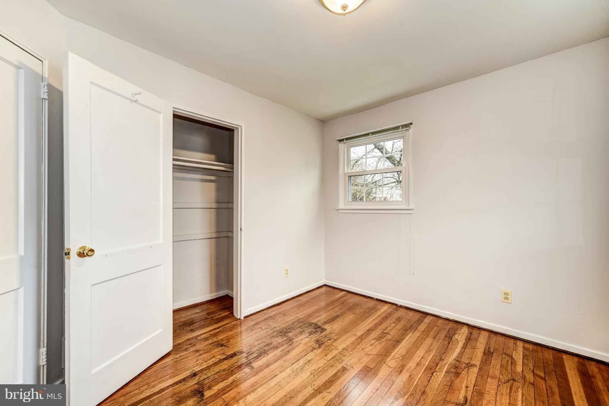 12036 Claridge Road Silver Spring, MD 20902 - Photo 17 of 27 an empty room with wooden floor and closet