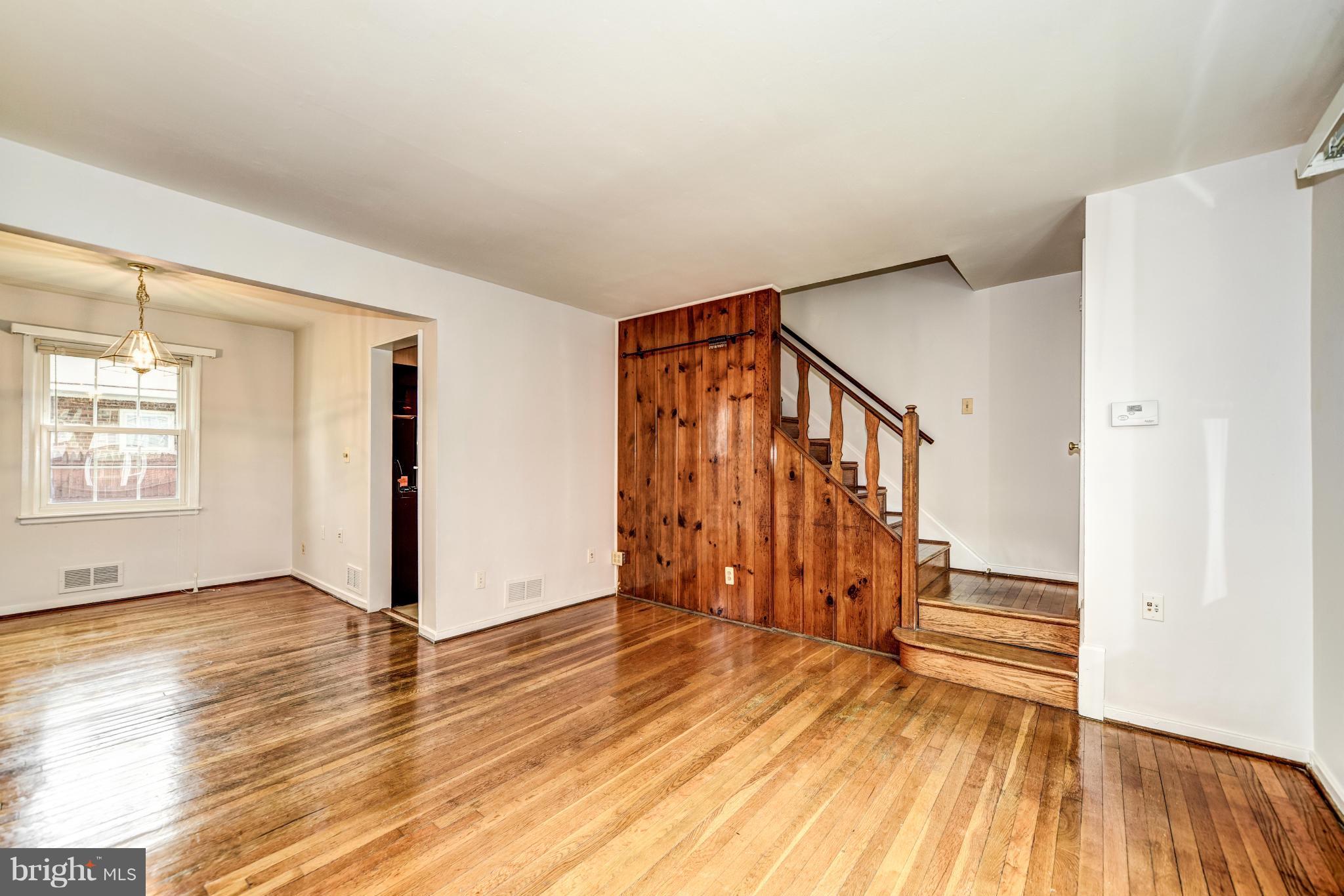 12036 Claridge Road Silver Spring, MD 20902 - Photo 3 of 27 a view of an empty room with wooden floor and stairs