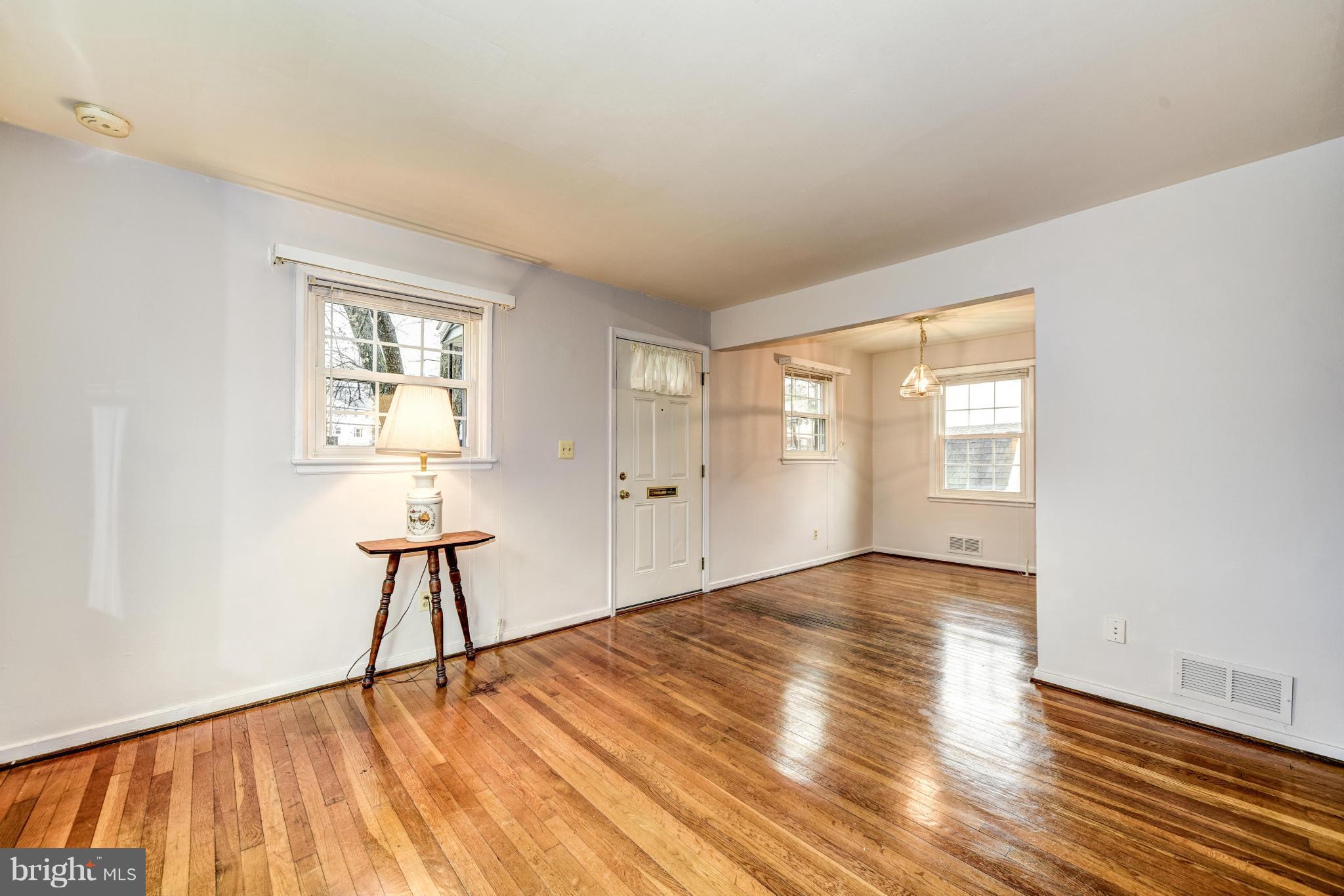 12036 Claridge Road Silver Spring, MD 20902 - Photo 4 of 27 an empty room with wooden floor and windows