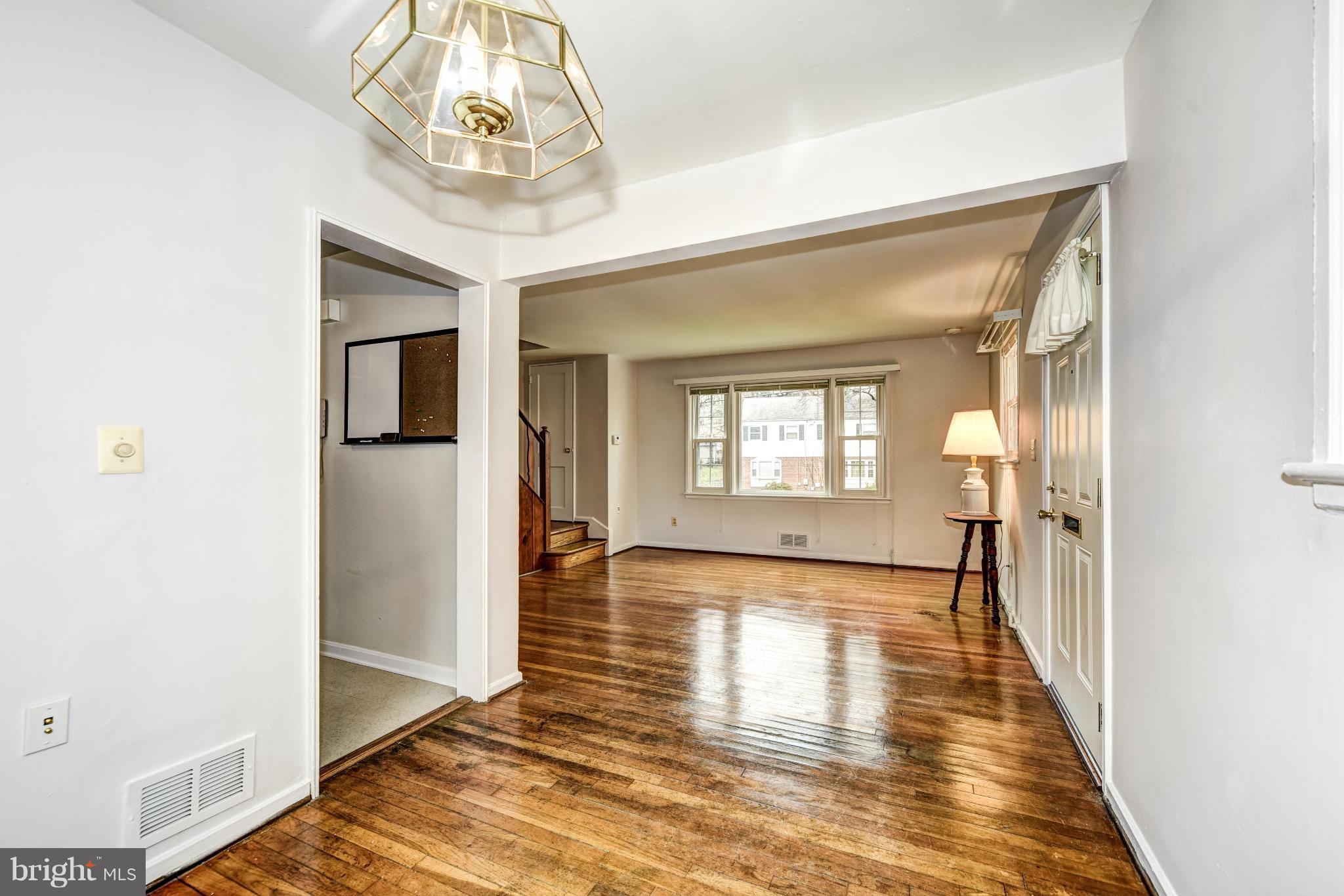 12036 Claridge Road Silver Spring, MD 20902 - Photo 5 of 27 a view of a hallway view with wooden floor and a dining room
