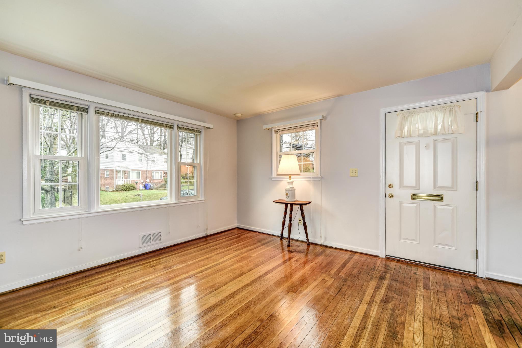 12036 Claridge Road Silver Spring, MD 20902 - Photo 6 of 27 a view of an empty room with wooden floor and a window