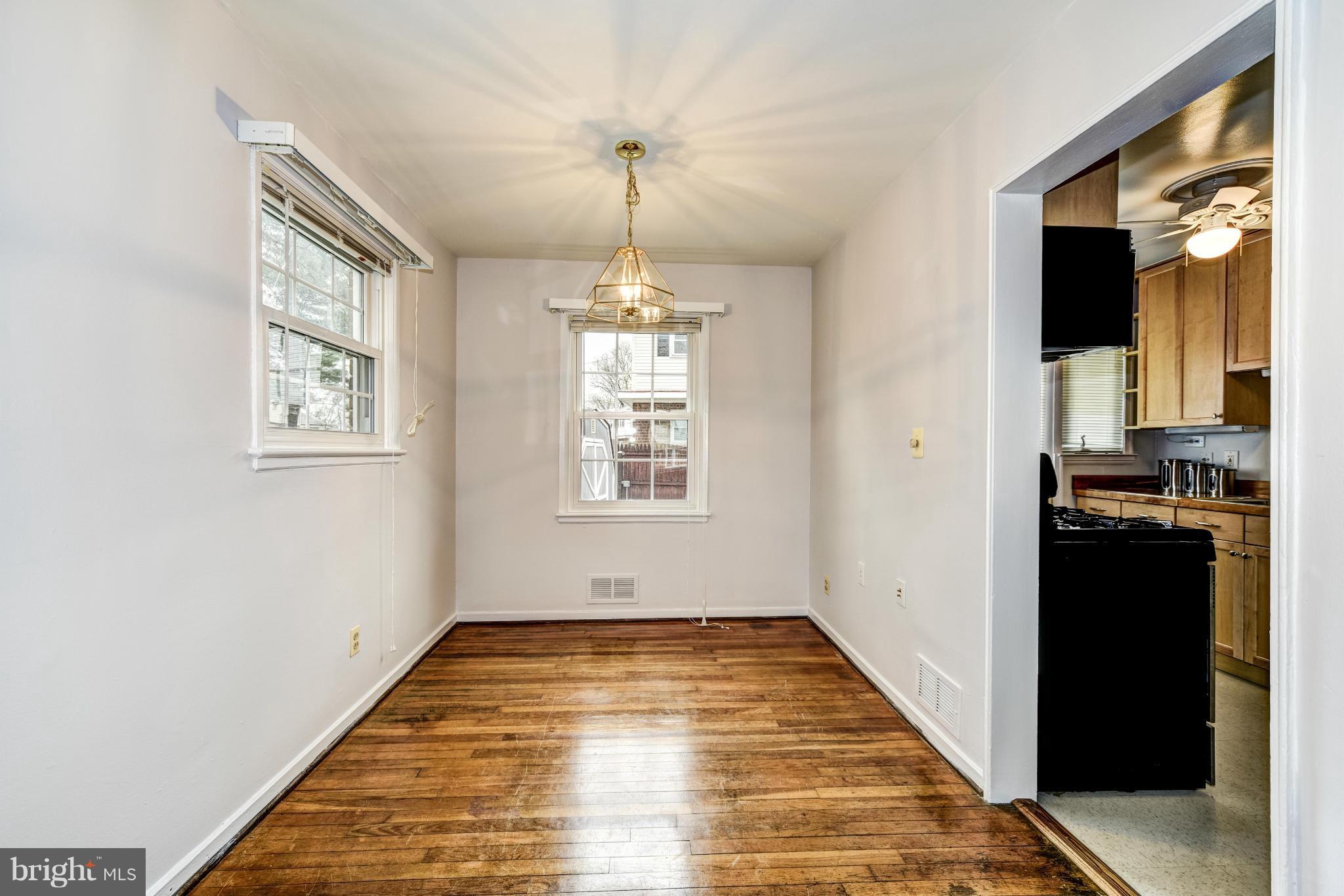 12036 Claridge Road Silver Spring, MD 20902 - Photo 8 of 27 a view of a hallway view with wooden floor and staircase