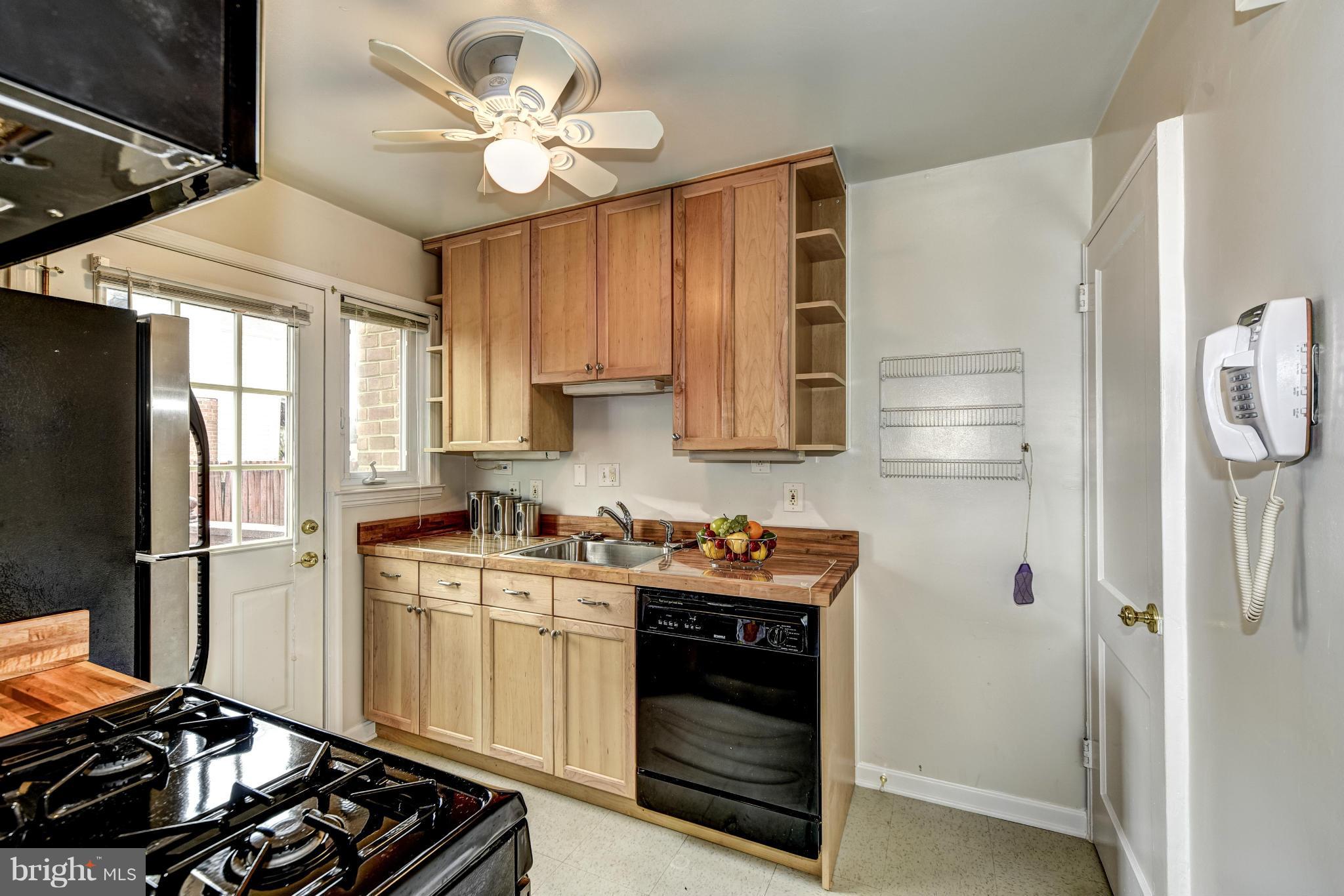12036 Claridge Road Silver Spring, MD 20902 - Photo 9 of 27 a kitchen with stainless steel appliances a stove a refrigerator and a sink
