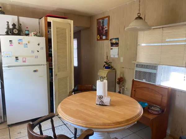 a dining table with chairs and wooden floor