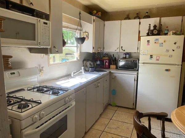 a kitchen with a stove a refrigerator and a sink