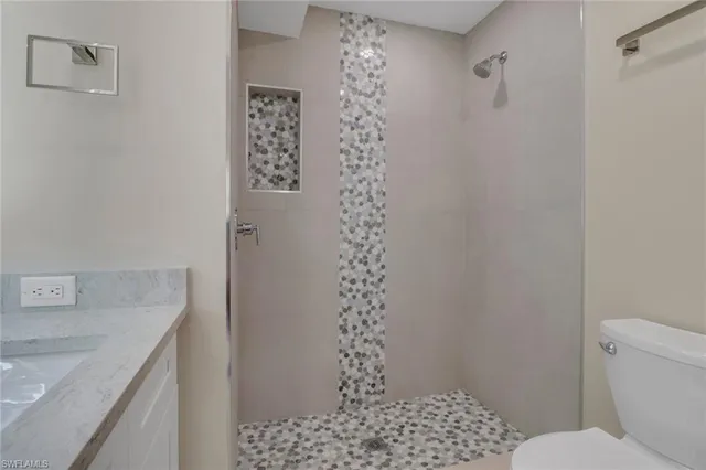 a bathroom with a sink toilet and shower