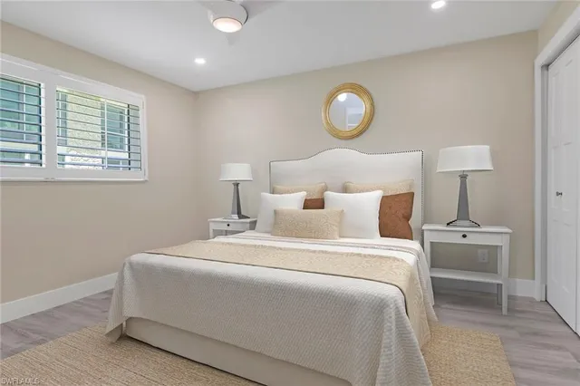 a bedroom with bed and a window