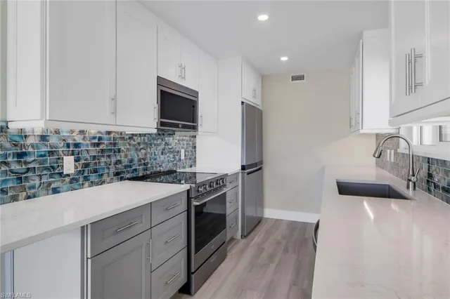 a kitchen with a sink stove and refrigerator