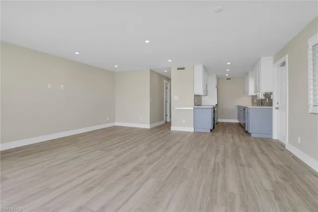a view of a kitchen with a sink and wooden floor