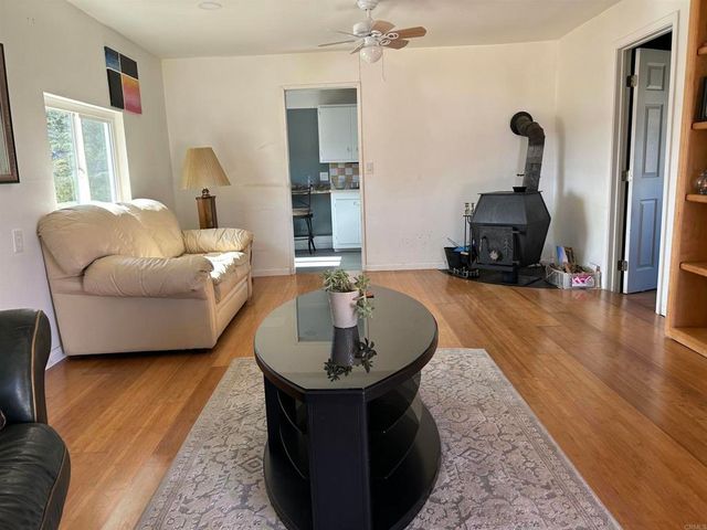 a living room with furniture and a mirror