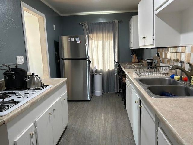 a kitchen with a refrigerator sink and stove