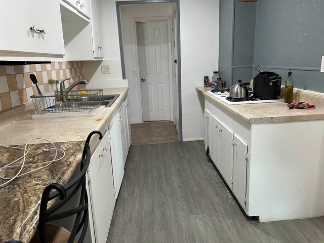 a kitchen with a sink stove and cabinets