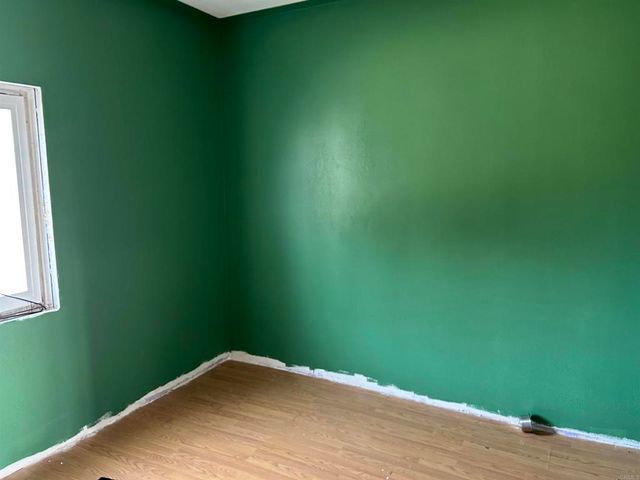 a view of a room with a wooden floor and a window