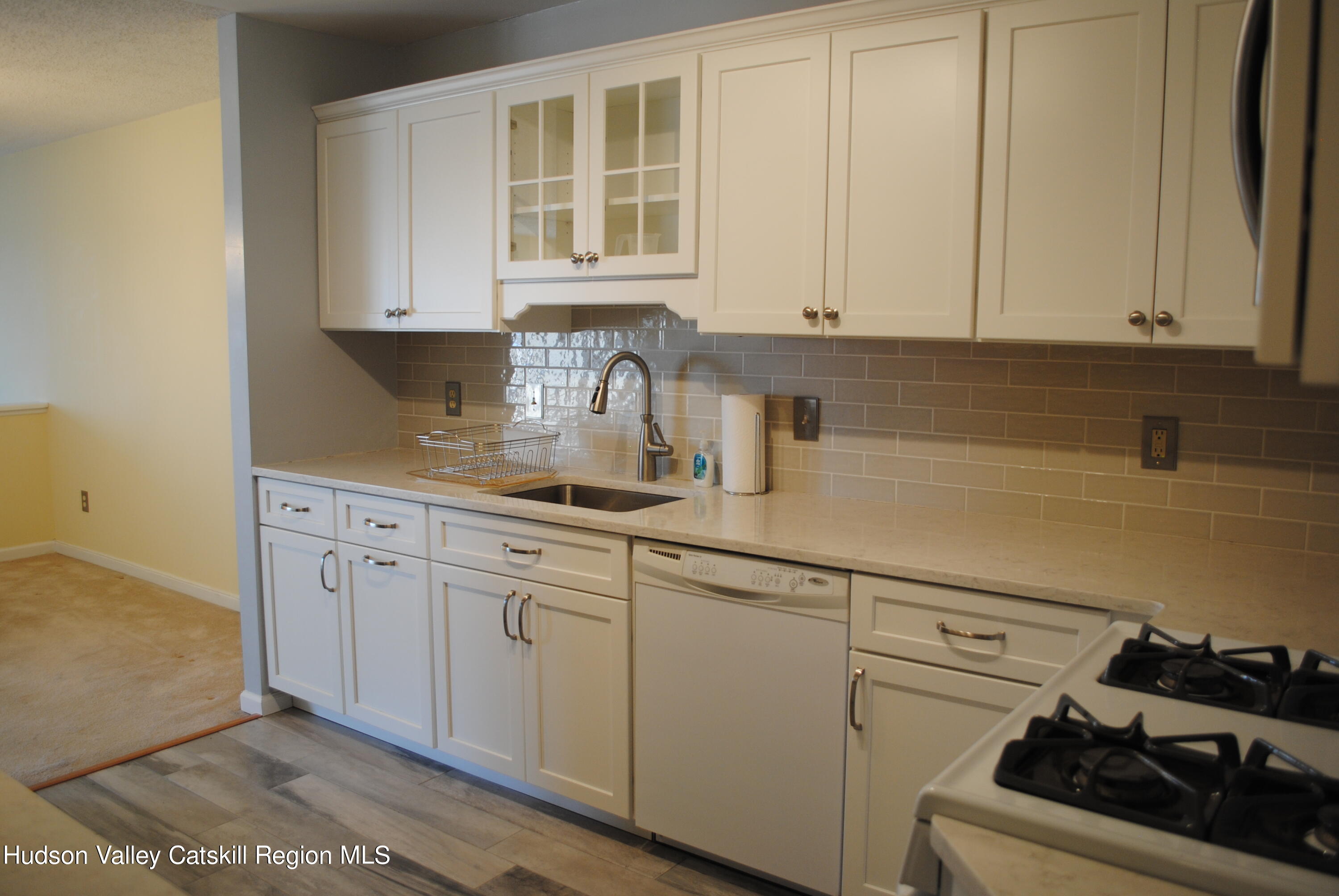 75 Riverview Port Ewen, NY 12466 - Photo 15 of 35 a kitchen with stainless steel appliances granite countertop white cabinets stove top oven and sink