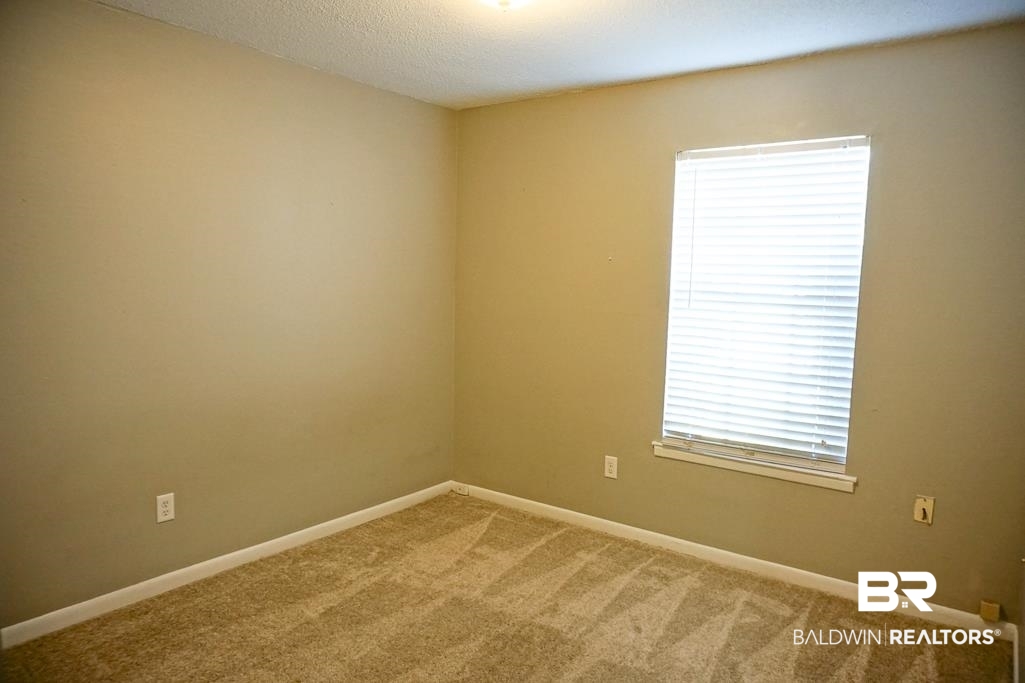 4366 Fathbrook Lane Mobile, AL 36693 - Photo 12 of 14 Carpeted spare room featuring baseboards