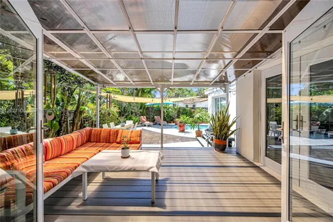 a outdoor space with the couches and dining table with the view of the glass door
