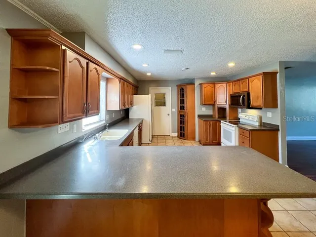 a kitchen with stainless steel appliances granite countertop a sink and a stove