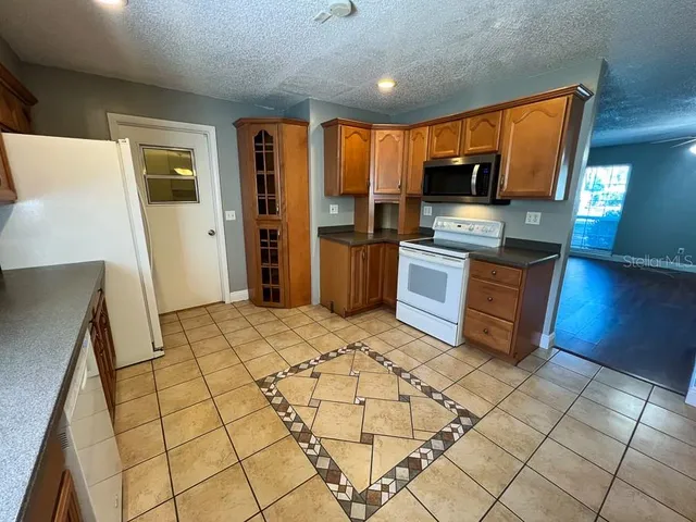 a view of an empty room and fire place
