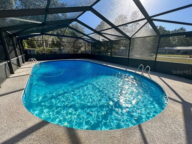 a view of a swimming pool with a yard