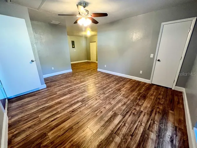 wooden floor in an empty room with a window