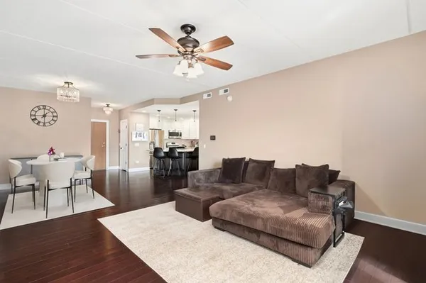 a living room with furniture and kitchen view