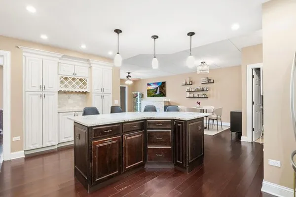 a kitchen with a table chairs refrigerator and cabinets