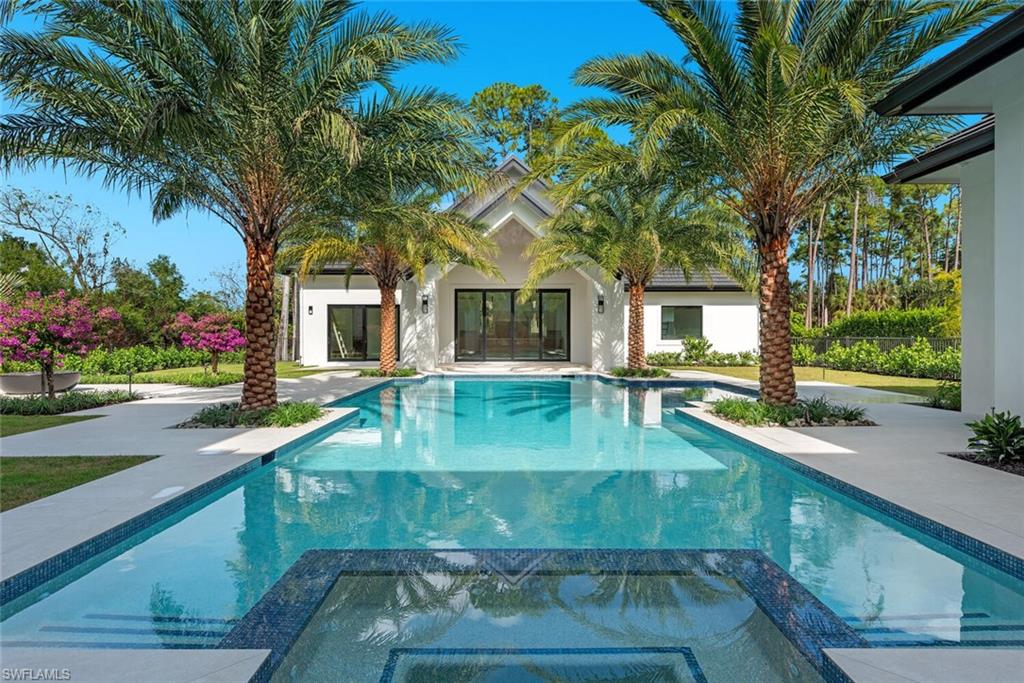 2145 Coach House Lane Naples, FL 34105 - Photo 4 of 9 a view of a house with a swimming pool