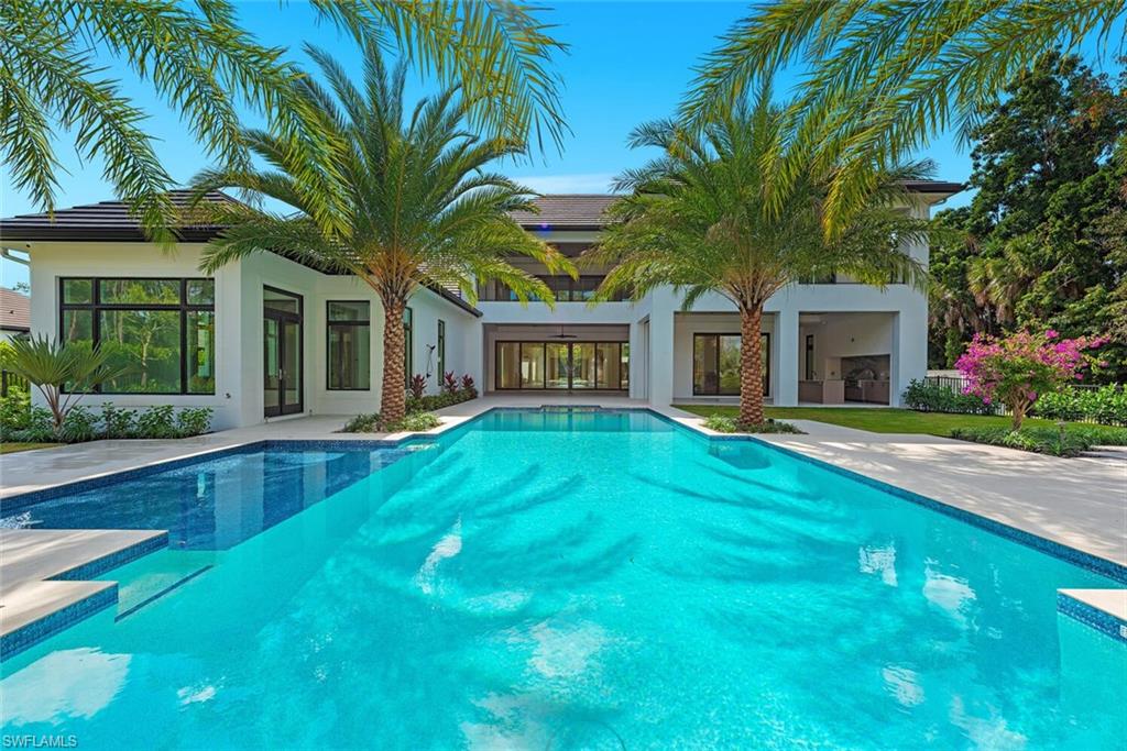 2145 Coach House Lane Naples, FL 34105 - Photo 5 of 9 a front view of house with yard and green space