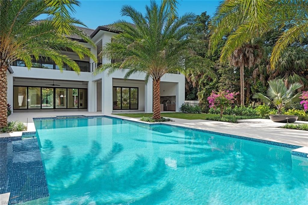 2145 Coach House Lane Naples, FL 34105 - Photo 6 of 9 a front view of house with yard and outdoor seating