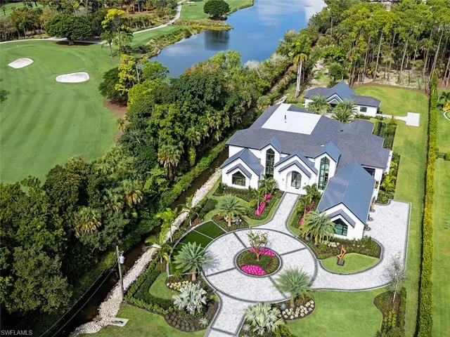 an aerial view of a house with yard swimming pool and outdoor seating