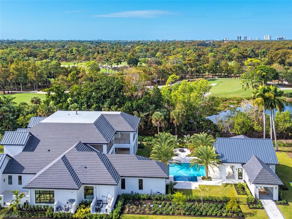 2145 Coach House Lane Naples, FL 34105 - Photo 8 of 9 an aerial view of residential houses with outdoor space and trees