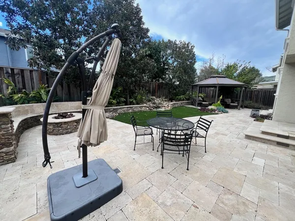 a view of a backyard with sitting area