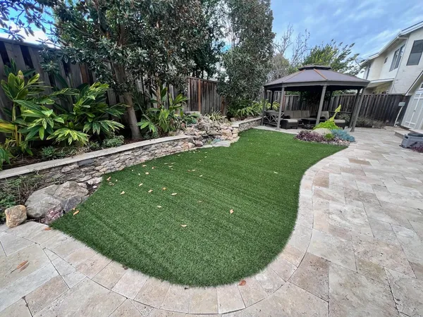 a view of a patio with chairs and plants