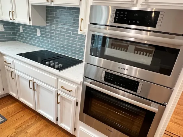 a kitchen with granite countertop a stove and a microwave