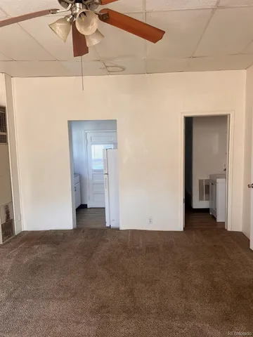 a view of a room with a ceiling fan