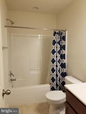 a bathroom with a toilet a sink and a shower