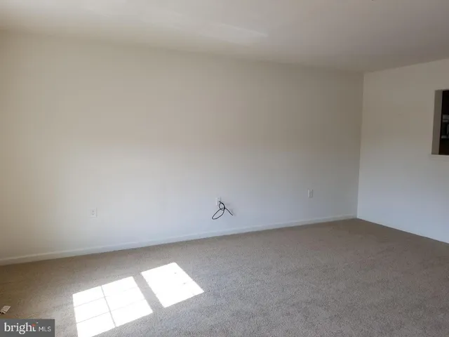 a view of an empty room and a window