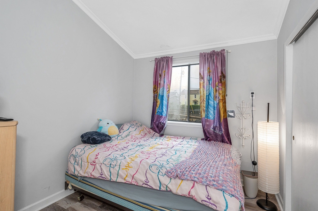 22 River Street, Unit 13 Hudson, MA 01749 - Photo 18 of 23 a bedroom with a bed and a large window